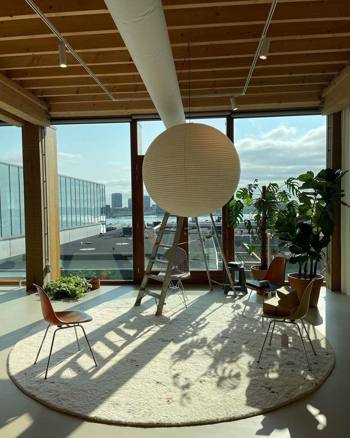 "Elegant modern Japanese paper lantern pendant light with a warm glow, blending contemporary and mid-century design."