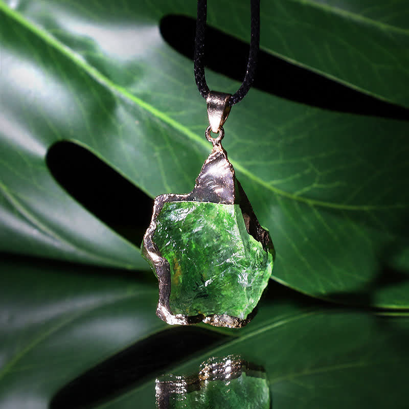 Elegant Moldavite necklace with unique design, featuring a green gemstone. Perfect for adding sophistication to any outfit.