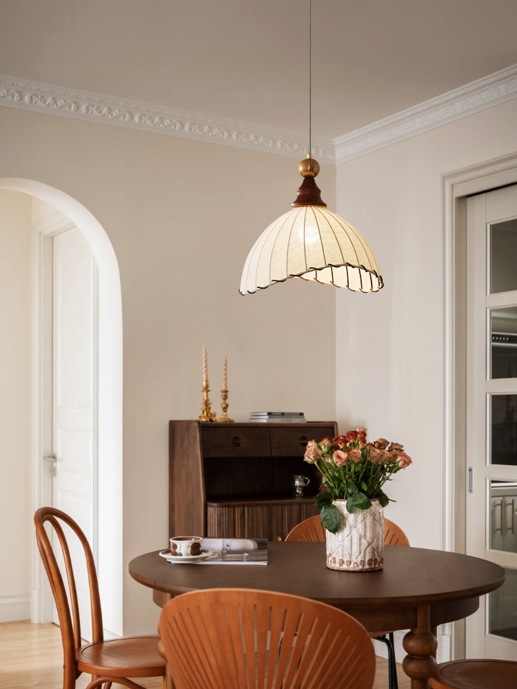 Elegant pendant light with pleated fabric shade, gold-finished top, and wood accent; perfect for modern interiors.