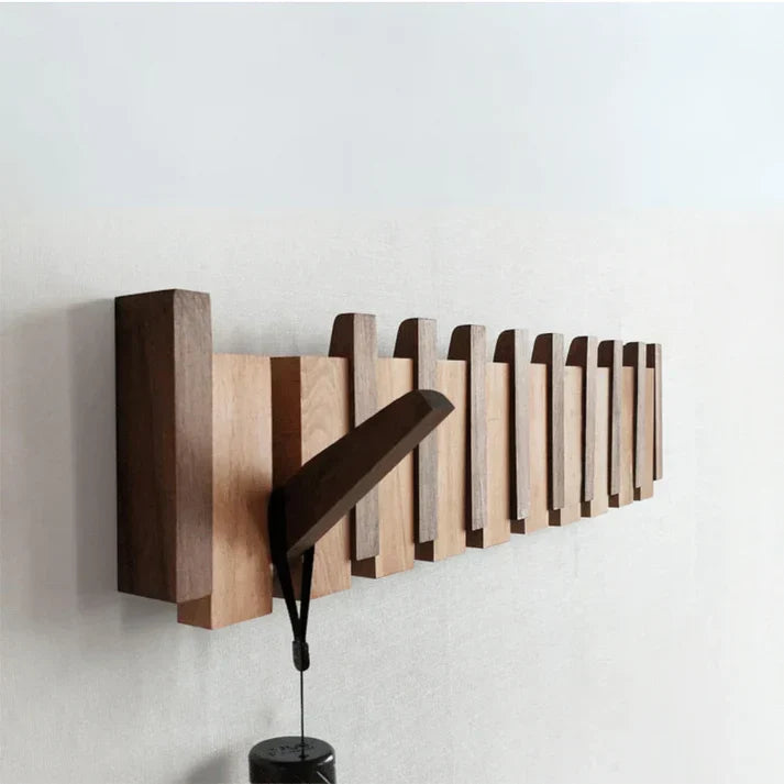 Elegant wall-mounted piano coat rack with multiple hooks, perfect for entryway organization and modern home decor.