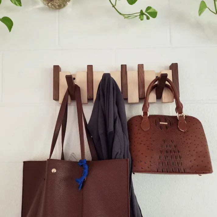 Stylish piano-style wood coat rack, a decorative wall-mounted hanger for modern entryway storage solution.