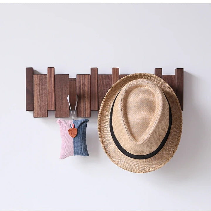 Functional wall-mounted coat rack for entryway. Piano key design offers multiple hooks for coats, hats, bags.