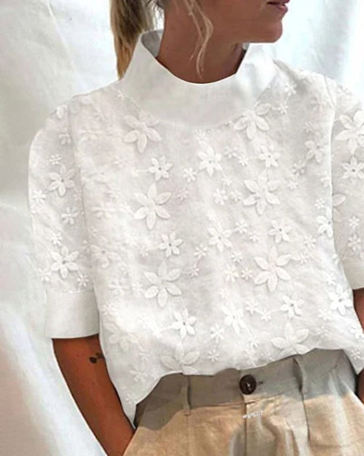 Elegant white women's blouse with delicate embroidery and a sophisticated stand-up collar, long sleeves for dressy wear.