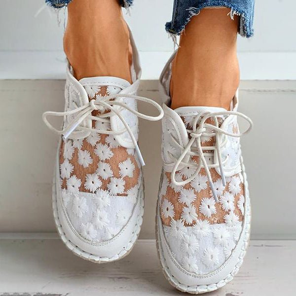 Elegant white women's floral embroidered lace-up sneakers, offering breathable comfort & casual fashion.