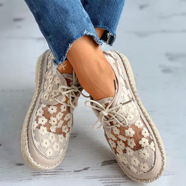 Breathable women's floral embroidered sneakers in elegant white, perfect for casual yet chic style.
