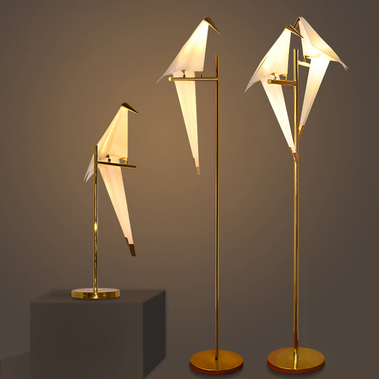 "Elegant wireless origami bird lamp with magnetic attachment emitting warm light; enhances home decor with artistic design."