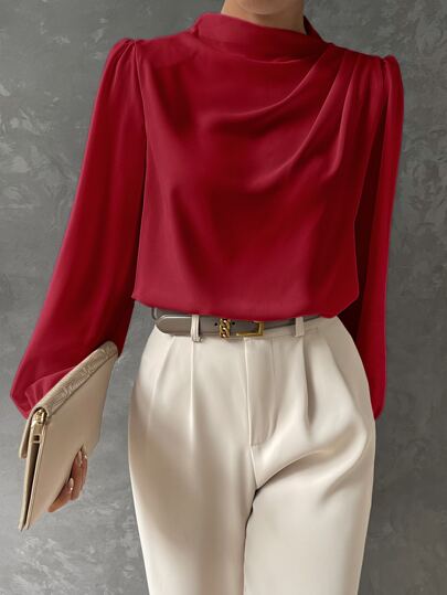 Woman modeling a stylish bishop sleeve blouse. Elegant long sleeve top, perfect for chic office or evening wear.