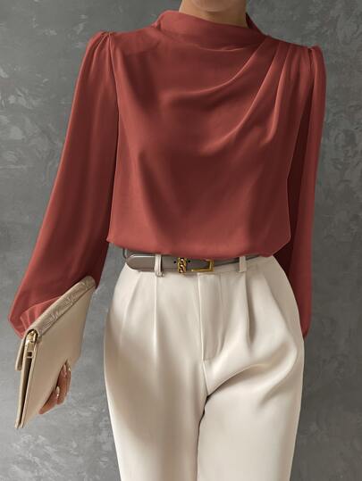 Lay-flat of a women's elegant bishop sleeve blouse. Versatile long sleeve top with draped neckline for chic apparel.