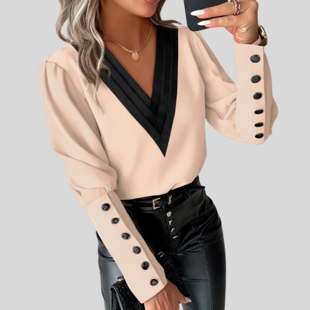 Modern women's button-front statement top with unique gigot sleeves, offering an elegant yet versatile option for office or casual wear.