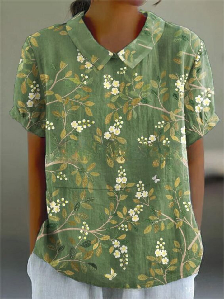 Women's breathable floral blouse, elegant design with a Peter Pan collar and short sleeves, chic apparel.