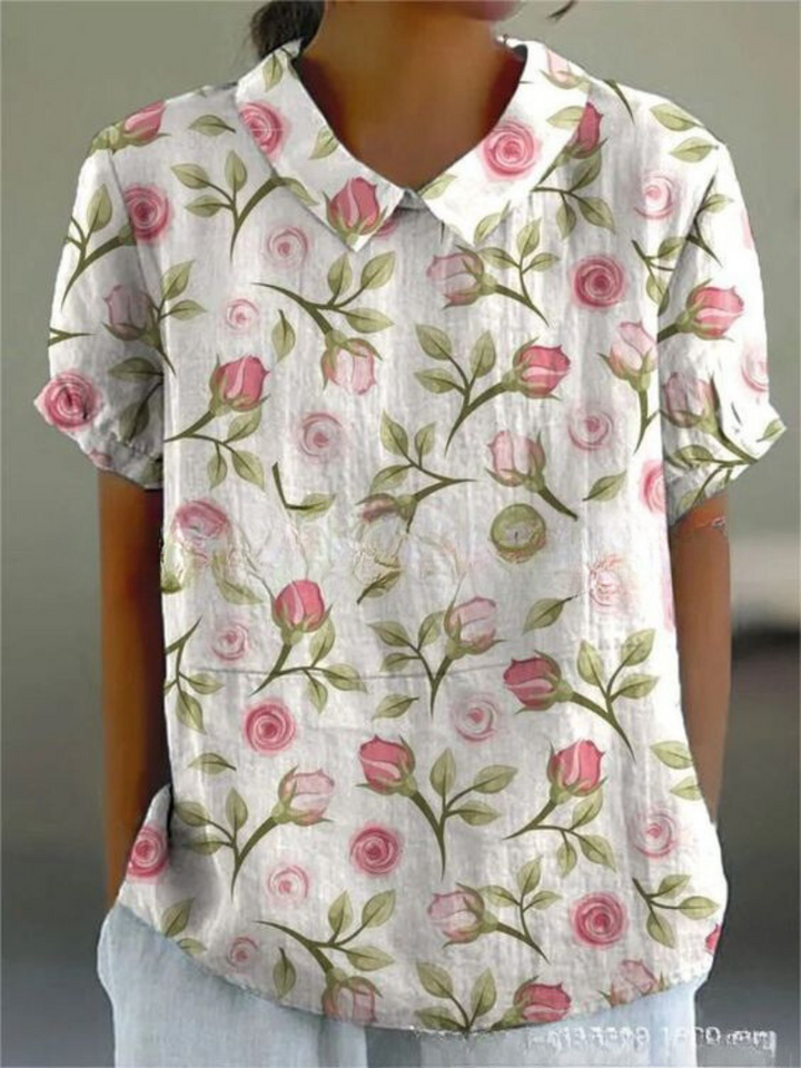 Sophisticated women's short-sleeve floral blouse with a Peter Pan collar, excellent for versatile summer fashion.