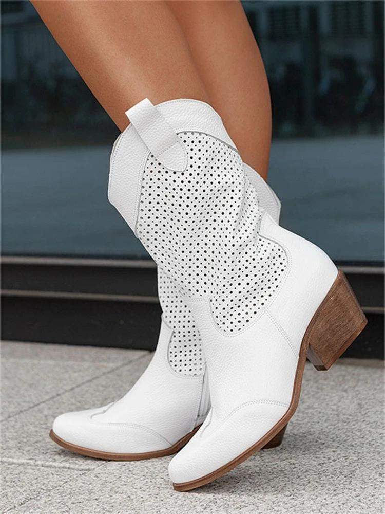Elegant women's heeled cowgirl boots. Chic western-style footwear with block heels, perfect for fashion-forward looks.