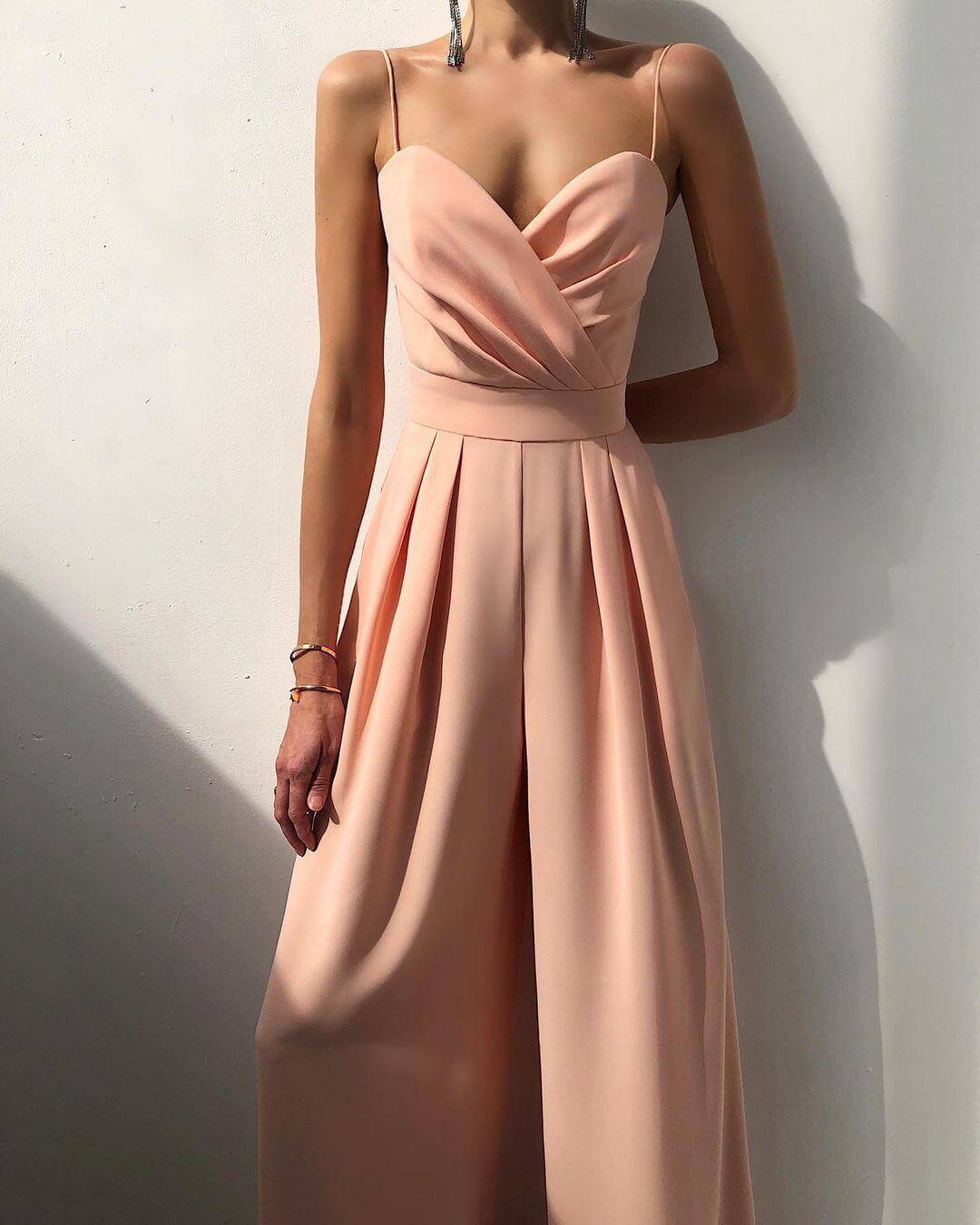 Back view of a women's stylish high-waist spaghetti strap jumpsuit, emphasizing comfortable fit.