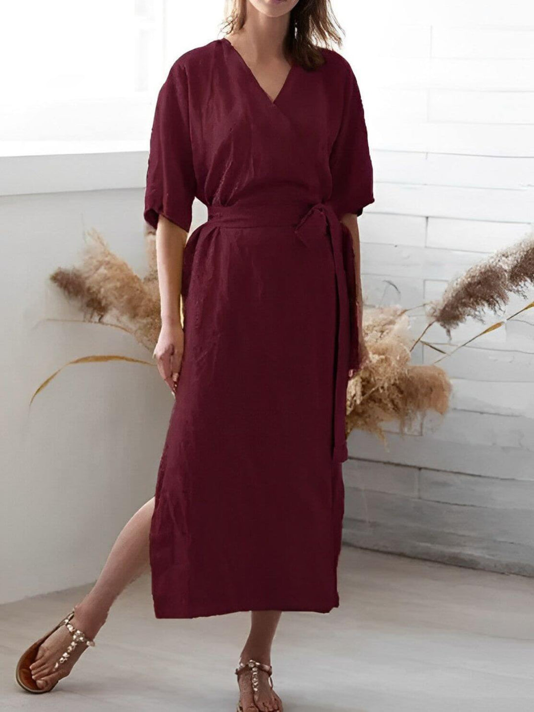 Close-up of a women's V-neck wrap dress, highlighting the adjustable belt detail and elegant neckline.