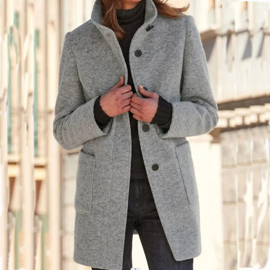 Elegant women's winter overcoat with button closure, standing collar, and classic design for cold weather fashion.