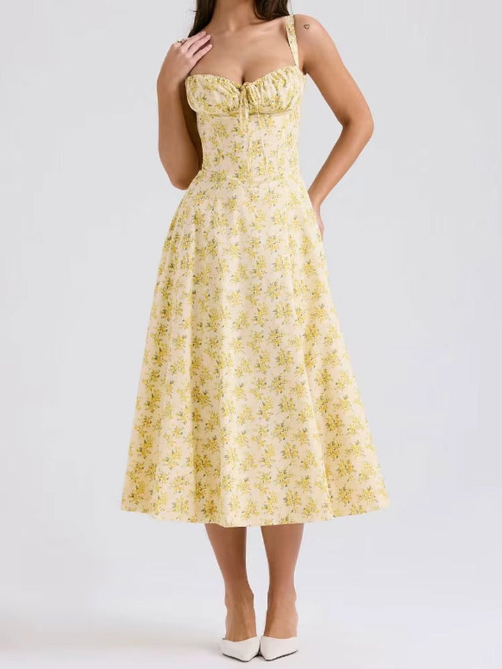 Elegant women's yellow floral midi dress. Perfect sleeveless summer vacation outfit, flowy and comfortable.