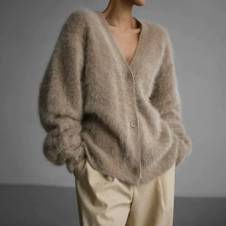"Elegant women's cashmere cardigan in soft grey, showcasing a luxurious knit texture for ultimate softness and comfort."