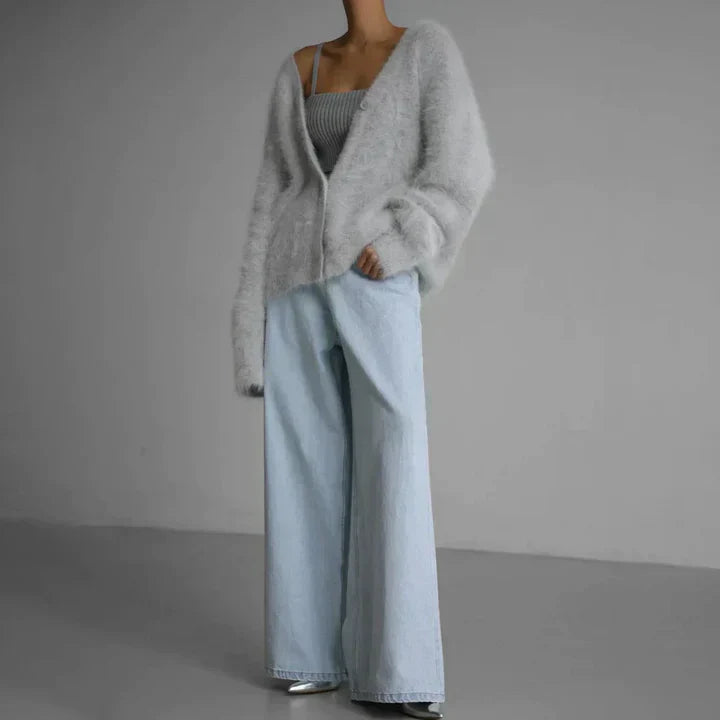 "Elegant women's cashmere cardigan in soft grey, showcasing a luxurious knit texture for ultimate softness and comfort."