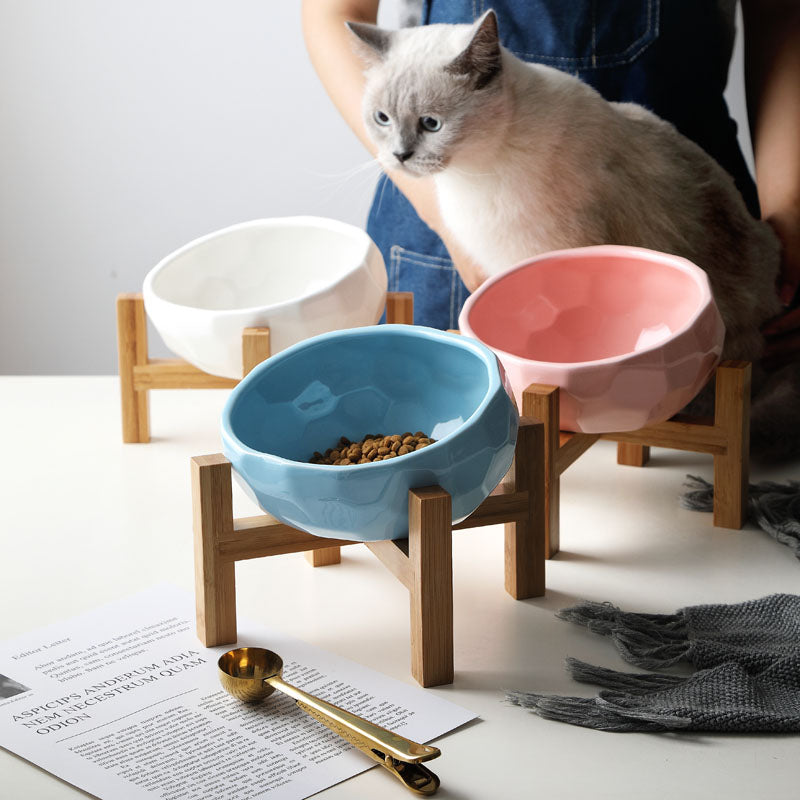 "Ergonomic elevated pet bowl with non-slip wooden stand, sleek design, blue color, enhances pet comfort and posture."