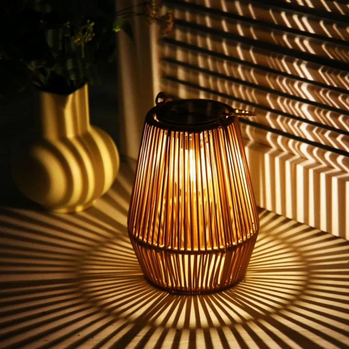 Handwoven solar garden lamp with intricate design, LED light, and waterproof finish, perfect for sustainable outdoor decor.