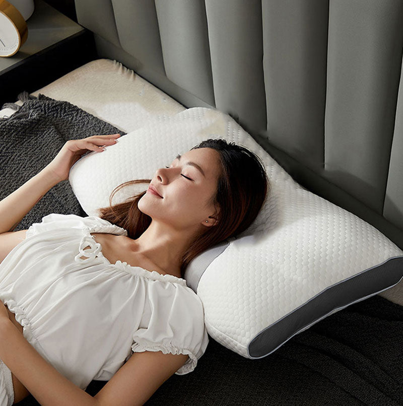 Hybrid pillow with ergonomic design, suited for back and side sleepers, featuring a neutral aesthetic and neck support.