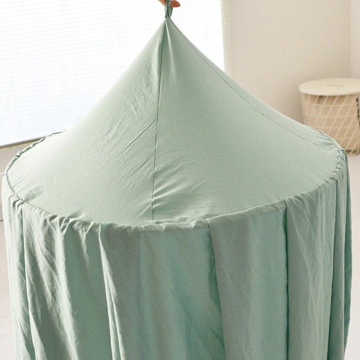 "Light green children's blackout bed canopy; elegant polyester fabric; blocks light; ideal for cribs, creating a cozy vibe."