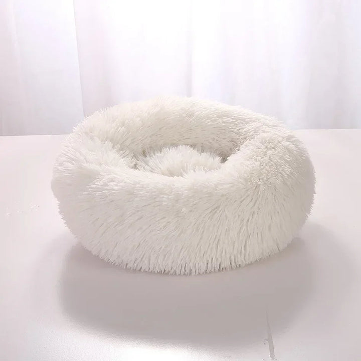 "Light grey premium dog bed offering comfort for pets, featuring plush design and elevated edges for head and neck support."