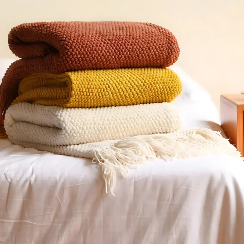 Luxury merino-style blanket with tassels and textured nubs; plush, elegant design perfect for home decor and warmth.