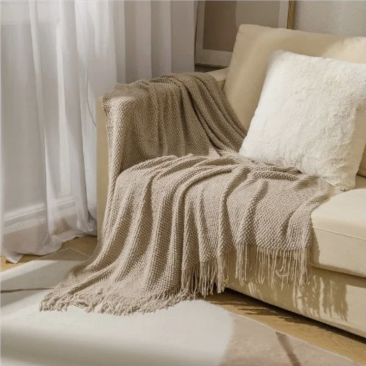 Luxury merino-style blanket with tassels and textured nubs; plush, elegant design perfect for home decor and warmth.