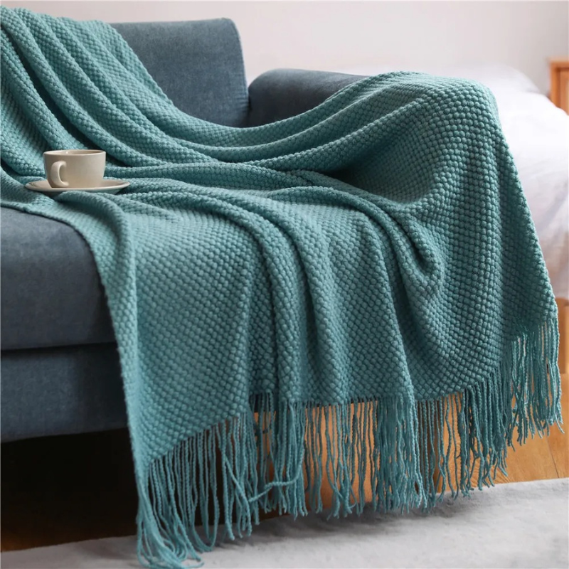 Luxury merino-style blanket with tassels and textured nubs; plush, elegant design perfect for home decor and warmth.
