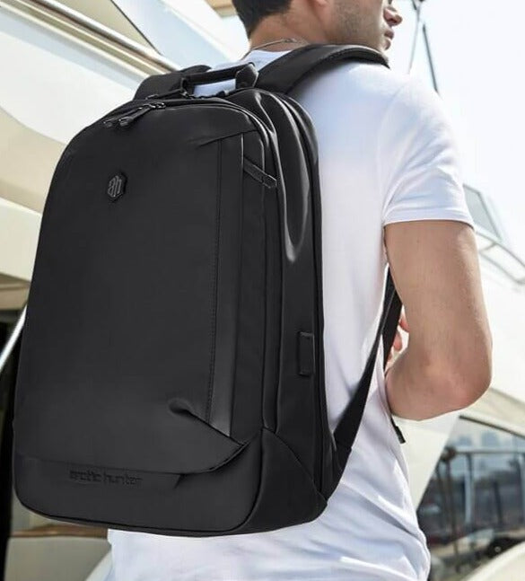 Man wearing a stylish anti-theft commuter backpack. Water-resistant and practical for daily use & laptop carry.