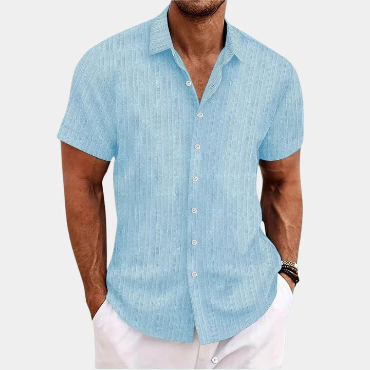 Side view of a man wearing a stylish, breathable short-sleeve button-up summer shirt.