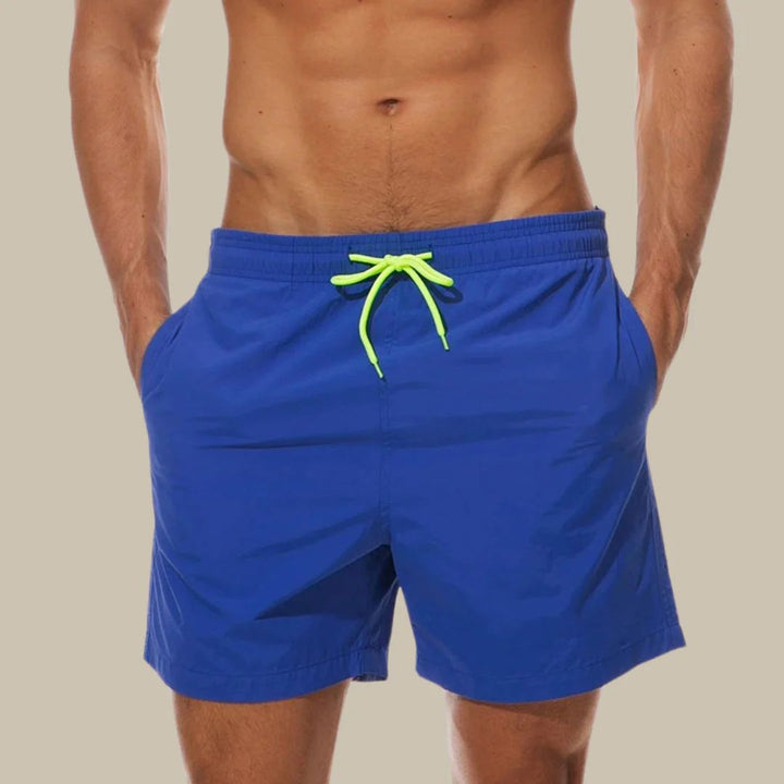 Quick-dry men's swimwear shorts for beach, pool, or vacation. Features comfy drawstring & pockets.