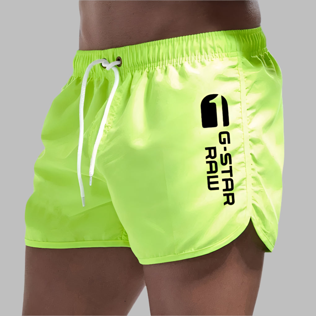 Athletic men's quick-dry swim trunks for swimming, beach sports, and travel. Comfortable solid design.