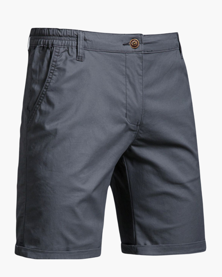 Man modeling tailored smart casual chino shorts, ideal for versatile summer and warm weather everyday wear.