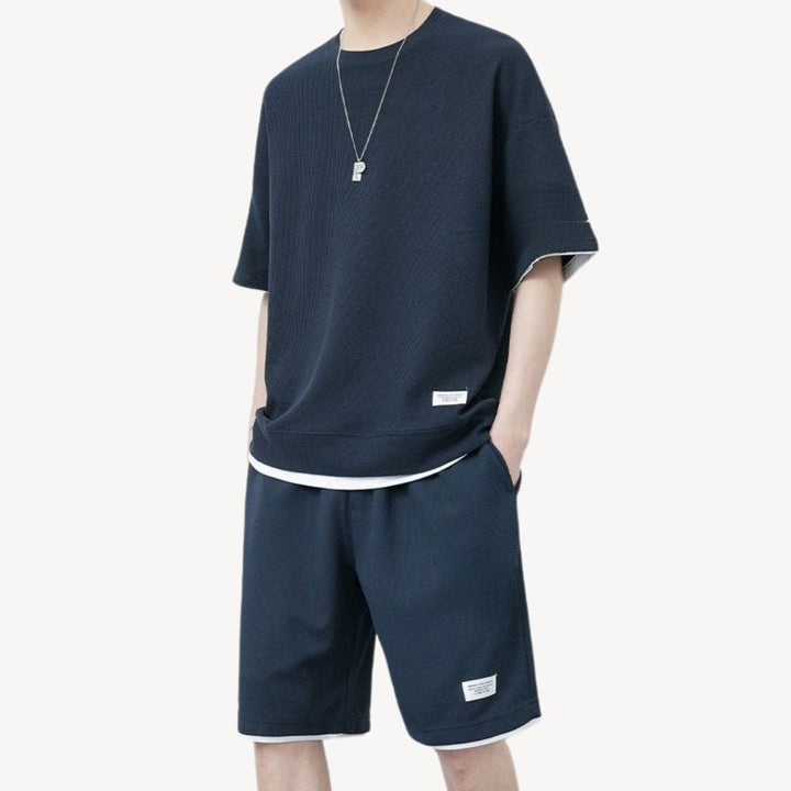"Men wearing dark gray cotton jersey shorts set, showcasing relaxed fit and minimalist design for casual comfort"