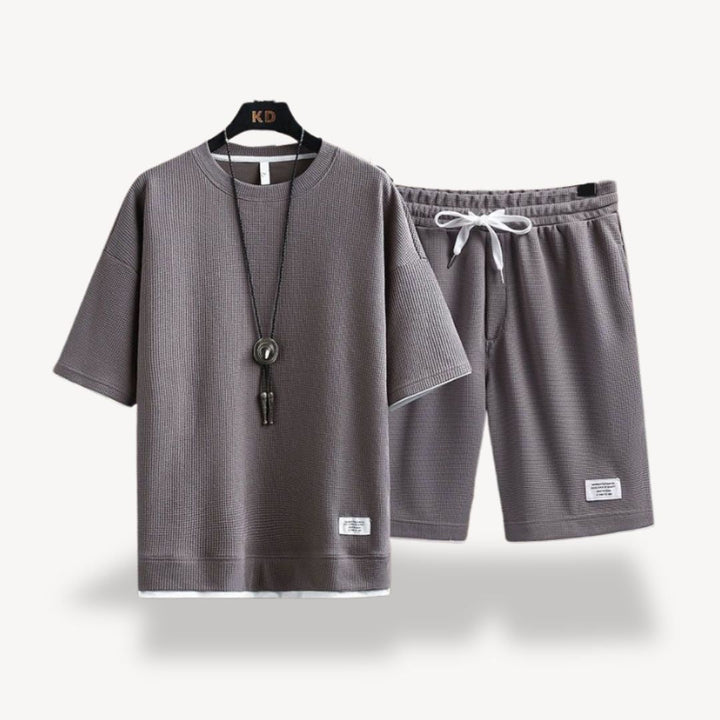 "Men wearing dark gray cotton jersey shorts set, showcasing relaxed fit and minimalist design for casual comfort"