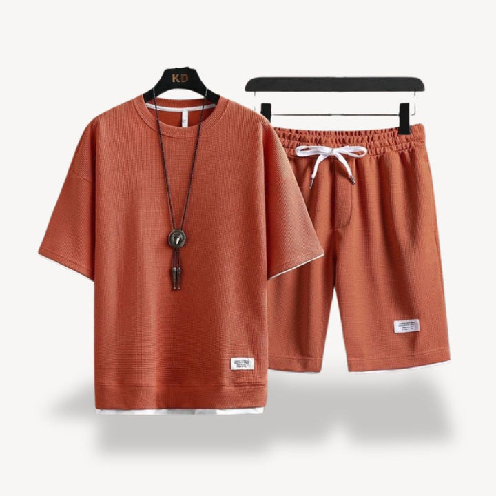 "Men wearing dark gray cotton jersey shorts set, showcasing relaxed fit and minimalist design for casual comfort"