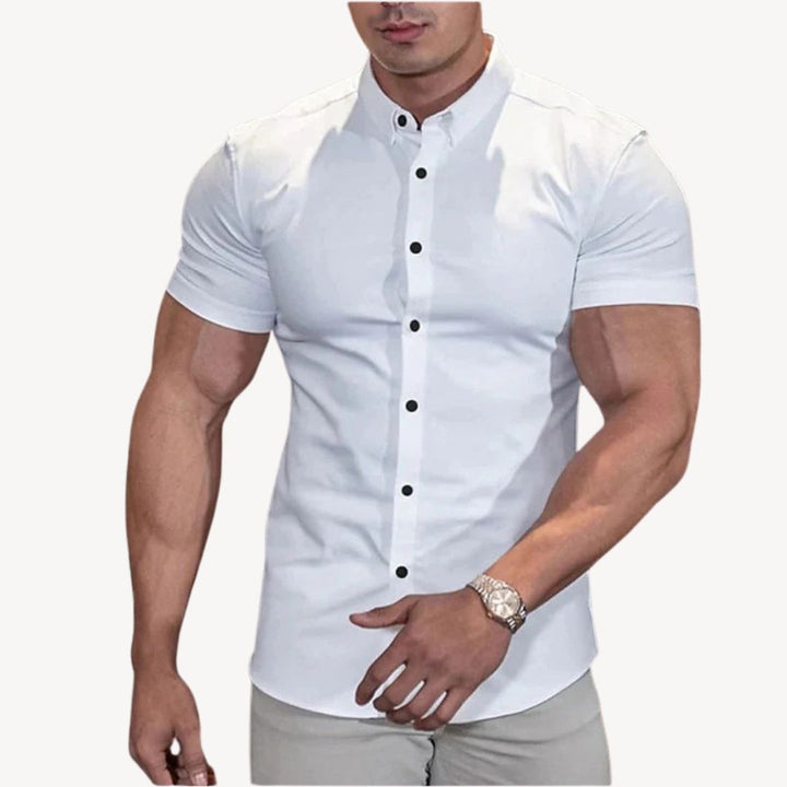 "Men's black muscle fit shirt, cotton spandex, short sleeve, highlighting athletic build, ideal for versatile styling."