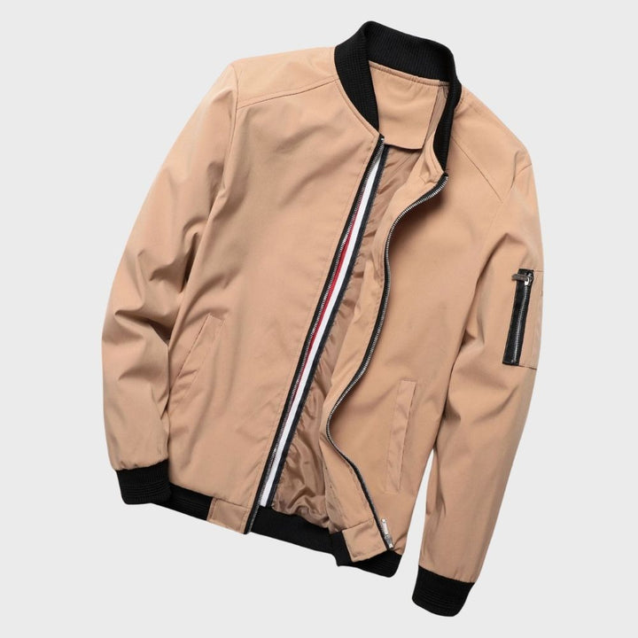 "Men's blue bomber jacket with zipper pockets, stylish fit, lightweight fabric, perfect for cool evenings."