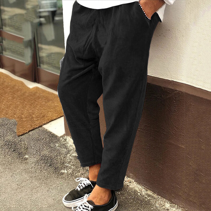 Men's corduroy trousers in green, side view showcasing casual elegance, perfect for versatile styling and comfort.