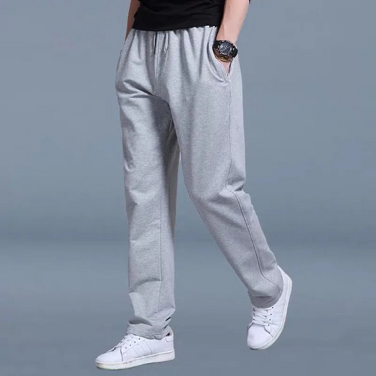Men's jogging pants with elastic waist, tapered fit, cuffed ankles, and pockets, perfect for comfort and style.