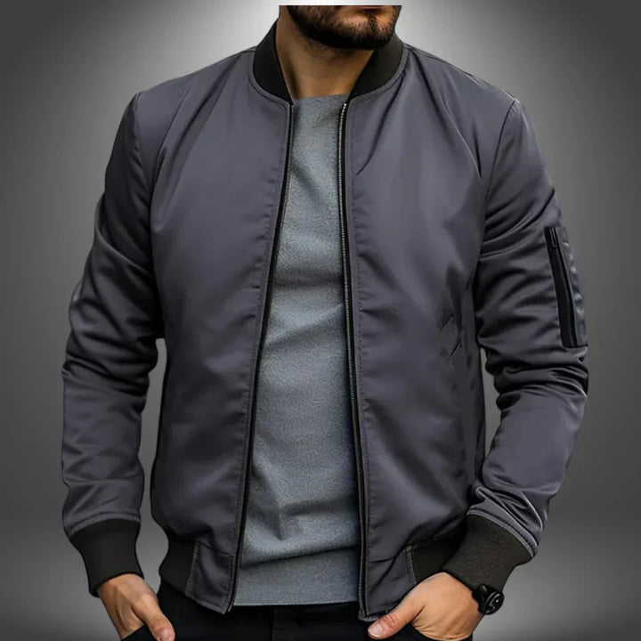"Men's lightweight bomber jacket, casual windbreaker style with slim fit, features ribbed cuffs and arm zip pocket."