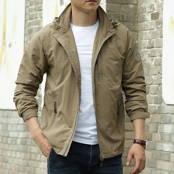 Men's lightweight breathable all-season jacket, sleek design, dark color, highlighting its comfort and versatility for layeri