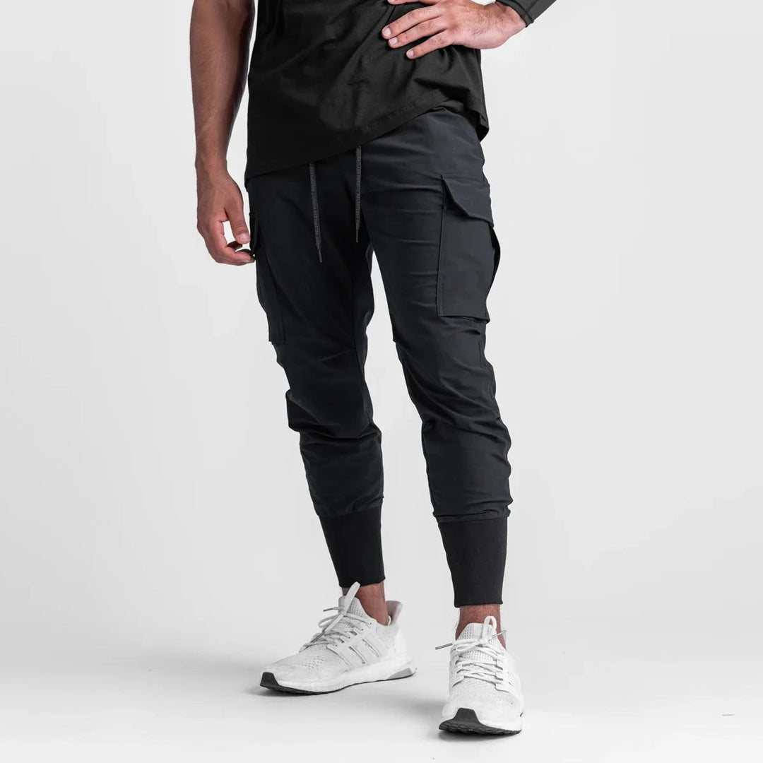 "Men's quick-dry cargo joggers, lightweight with multiple pockets, elastic cuffs, urban style, navy color, displayed front vi
