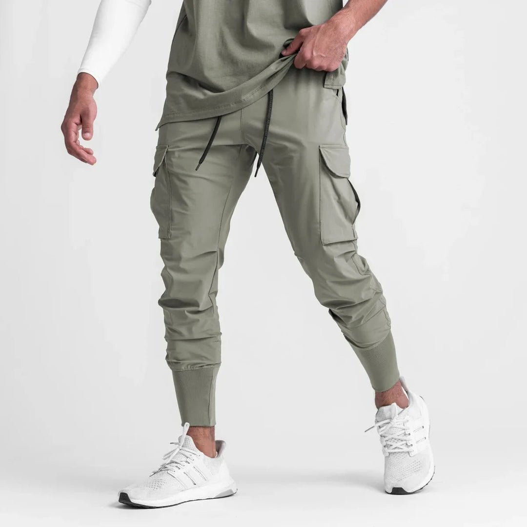 "Men's quick-dry cargo joggers, lightweight with multiple pockets, elastic cuffs, urban style, navy color, displayed front vi