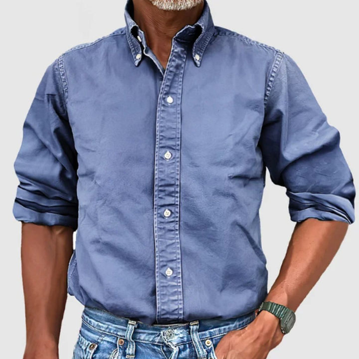 "Men's regular fit long-sleeve button-down shirt with classic collar, rolled cuffs, and durable polyester fabric."