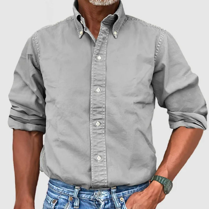 "Men's regular fit long-sleeve button-down shirt with classic collar, rolled cuffs, and durable polyester fabric."