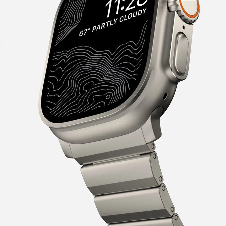Men's sleek titanium watch band with shiny finish, magnetic clasp, durable and lightweight; perfect for daily or formal wear.