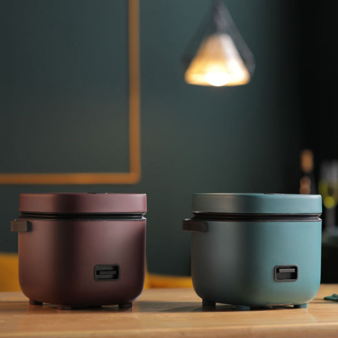 "Mini rice cooker and steamer, compact design for 1-2 people, 1.2L capacity, in green, ideal for small kitchens or travel."